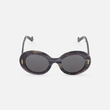Loewe Round Grey-black Sunglasses by LOEWE feature marble-inspired round frames, dark grey lenses, gold oval accents beside the frames, and curved arms, shown against a plain white background.
