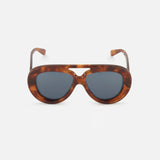 The LOEWE Aviator Brown Tortoiseshell Sunglasses are displayed against a plain white background. These sunglasses by LOEWE feature thick, oval frames in a brown tortoiseshell pattern with dark lenses and a keyhole bridge, combining timeless style with modern design elements.