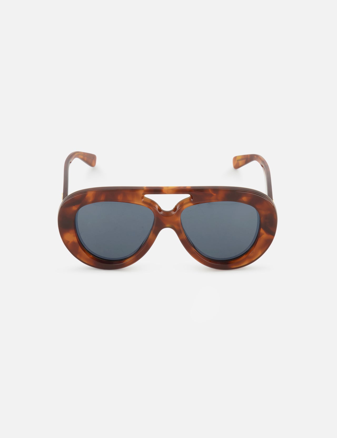 The LOEWE Aviator Brown Tortoiseshell Sunglasses are displayed against a plain white background. These sunglasses by LOEWE feature thick, oval frames in a brown tortoiseshell pattern with dark lenses and a keyhole bridge, combining timeless style with modern design elements.