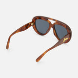 The Loewe Aviator Brown Tortoiseshell Sunglasses by LOEWE feature thick frames and dark lenses, shown at an angle to highlight the gold LOEWE branding on the left arm—these statement aviators put a bold spin on the classic silhouette.