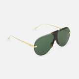 The LOEWE Aviator Gold Sunglasses feature a frameless design with large green-tinted visor lenses, gold metal arms, and a tortoiseshell bridge, showcased against a light background.