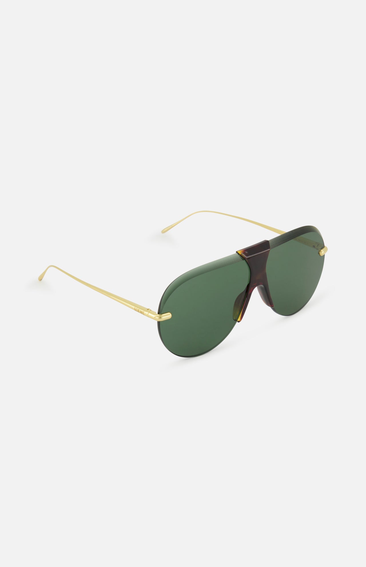 The LOEWE Aviator Gold Sunglasses feature a frameless design with large green-tinted visor lenses, gold metal arms, and a tortoiseshell bridge, showcased against a light background.