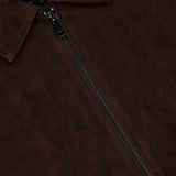 Close-up of the THEORY Aviator Lamb Leather Jacket for men in dark brown, featuring a visible zipper, collar, soft leather texture, and part of the inner label.