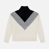 The THEORY Cashmere Chevron Yoke Sweater features a large black and gray chevron pattern on the upper white body, finished with a high collar plus ribbed cuffs and hem.