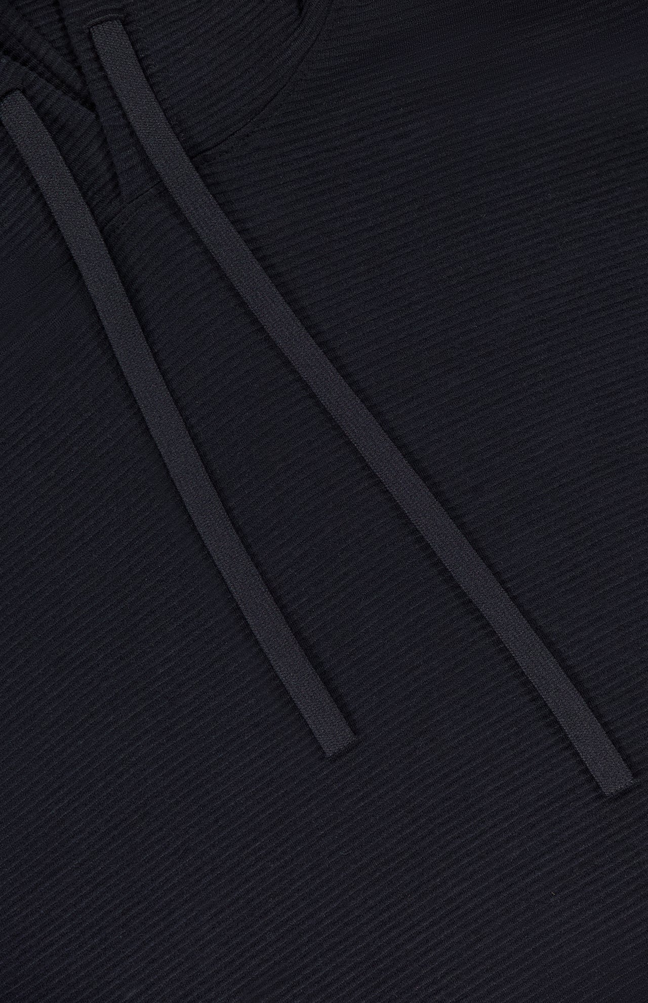 Close-up of the THEORY Delory Drawstring Hoodie Sweater in black, showing two flat black drawstrings lying diagonally across the textured knit fabric.