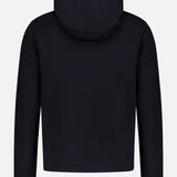 The Delory Drawstring Hoodie Sweater by THEORY is a plain black knit top with a drawstring hood, long sleeves, and a simple design, shown from the back against a light gray background.