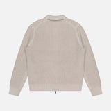 The THEORY Gary Zip Sweater Jacket, shown from the back on a white background, is beige with long sleeves, a ribbed texture, collar, zip front, and ribbed cuffs and hem. Crafted from a cotton-cashmere blend.