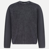 The THEORY Breach Wash Long Sleeve Crewneck Sweater is a dark gray, ribbed lightweight pullover with a round neckline and a simple, casual design, shown on a plain white background. No visible patterns or logos.