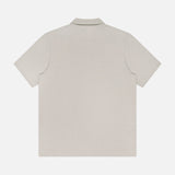 Back view of the THEORY Bron Cosmos Polo Shirt for men in light beige, featuring a classic collar and minimalist design—perfect for those who appreciate the understated style of a light grey polo shirt.
