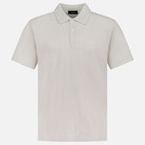 The THEORY Bron Cosmos Polo Shirt is a versatile men's top in light beige, featuring short sleeves, a collar, and three front buttons, displayed against a white background.