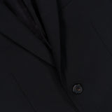 Close-up of the THEORY Chambers Blazer in Stretch Wool, shown in black, highlighting two buttons, a portion of the lapel, and a breast pocket.