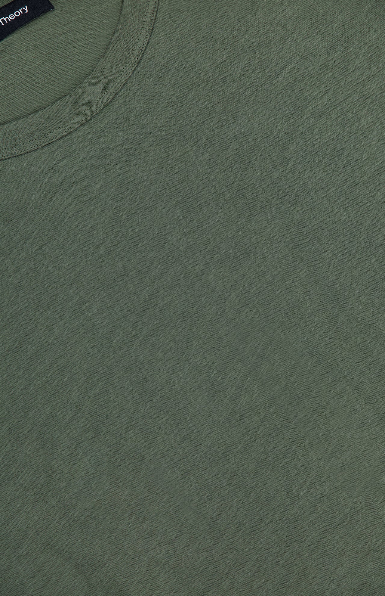 Close-up of the Cosmos Essential T-shirt by THEORY in olive green, highlighting the soft Peruvian cotton fabric, detailed texture, and neckline stitching.