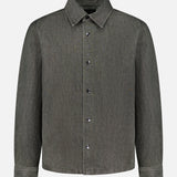 The THEORY Denim Snap-front Overshirt is a long-sleeve, button-up shirt jacket crafted from faded dark gray stretch-cotton denim. Featuring a pointed collar, chest pocket, and a simple, clean design, it serves as an ideal lightweight jacket for versatile layering.