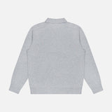 The Goris Long Sleeve Polo Sweater by THEORY is displayed from the back, showcasing its light gray color, classic collar, and minimalist plain design with no visible logos, patterns, or embellishments. The knit top is laid flat against a white background.