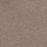 Close-up of the Hilles Cashmere Crewneck Sweater in light brown, featuring a minimalist knit design with a ribbed crew neckline. A black THEORY brand tag displaying the size M is visible at the top left of the image, emphasizing this classic sweater’s refined simplicity.
