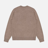 The Hilles Cashmere Crewneck Sweater by THEORY is displayed flat with the back facing up against a white background. This minimalist, long-sleeve sweater comes in a light brown hue and features a classic crew neckline, ribbed cuffs, and a ribbed hem.