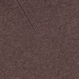 Close-up of the Hilles Cashmere Quarter Zip Sweater by THEORY, a men’s brown sweater crafted from luxurious cashmere, featuring a ribbed collar and a partial zipper at the neckline—exemplifying the refined style of this classic quarter-zip design.