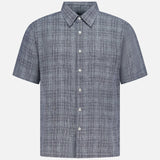 The THEORY Irving Short Sleeve Relaxed Shirt features a blue and gray plaid pattern, classic collar, white buttons, and a relaxed fit, shown on a plain white background.
