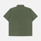 Back view of the THEORY Irving Short Sleeve Structure Shirt, featuring a wrinkle-free green fabric, straight hem, and classic collar, shown against a plain white background.