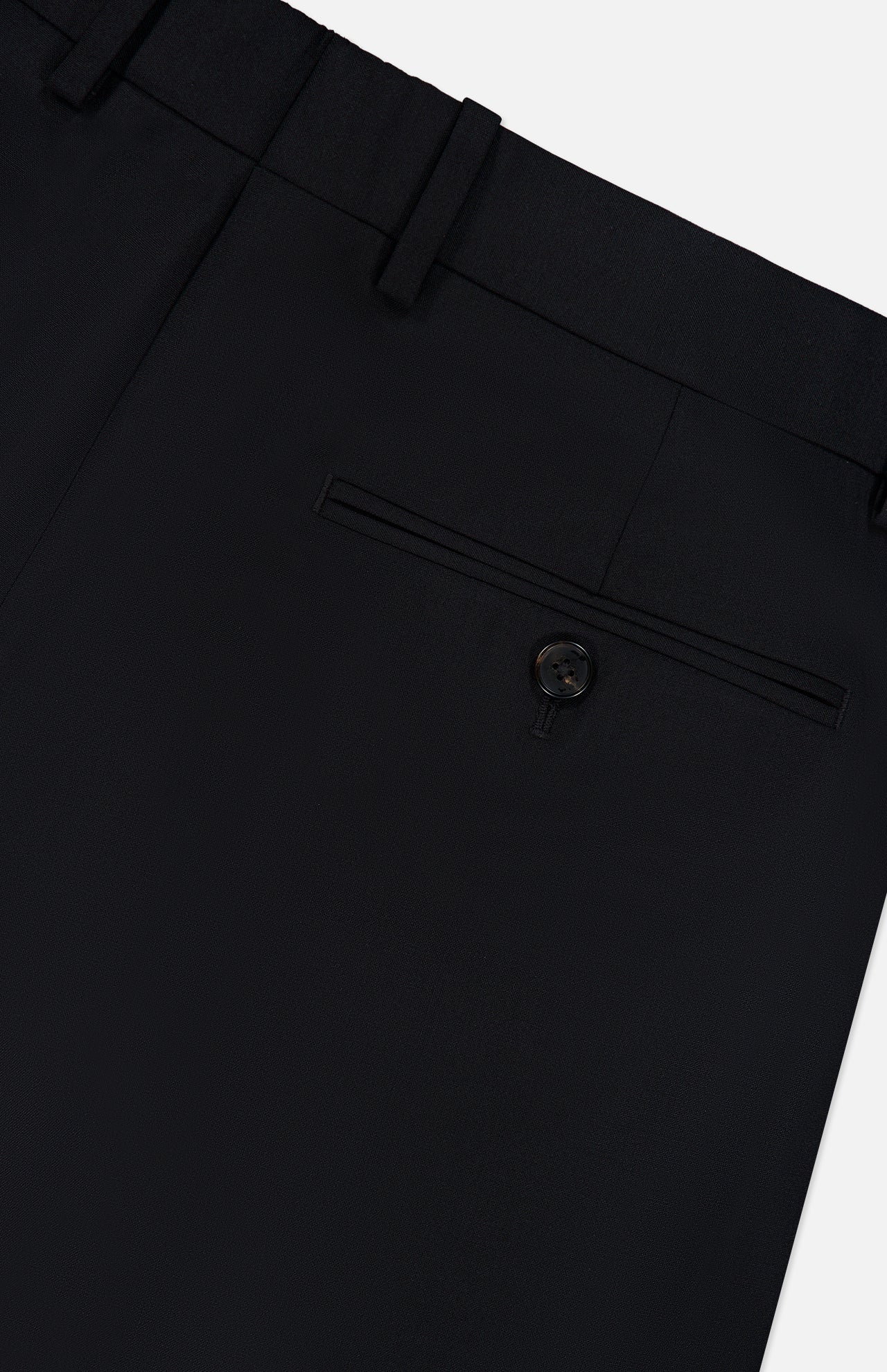 Close-up of the back pocket of the Mayer Pant in Stretch Wool by THEORY, featuring a single welt pocket with button closure and visible belt loops along the waistband. Expertly tailored in a slim fit, these trousers are crafted from luxurious Italian stretch wool suiting for timeless sophistication.