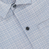 Close-up of a white Mini Tex Short Sleeve Shirt by RAG & BONE, featuring a blue grid pattern, three dark buttons, and a visible collar—perfect for a polished casual office look.