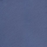 A close-up of the Regal Crew Neck Sweater in dusty blue, featuring a visible THEORY brand label near the collar.