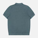 The THEORY Silk Cotton Polo Shirt in rich teal is shown from the back, laid flat on a white background, featuring a simple collar, button-front placket, and ribbed waistband.