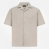 The THEORY Soft Terry Short Sleeve Shirt features a relaxed fit, notched collar, and beige cotton fabric—perfect as a casual work shirt. Displayed on a plain white background.