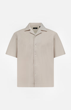 The THEORY Soft Terry Short Sleeve Shirt features a relaxed fit, notched collar, and beige cotton fabric—perfect as a casual work shirt. Displayed on a plain white background.