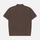 The THEORY Soris Short Sleeve Polo Shirt is displayed from the back, laid flat on a plain white background. This men’s transitional knit polo features a classic collar and a minimalist design with no visible logos, patterns, or extra details.