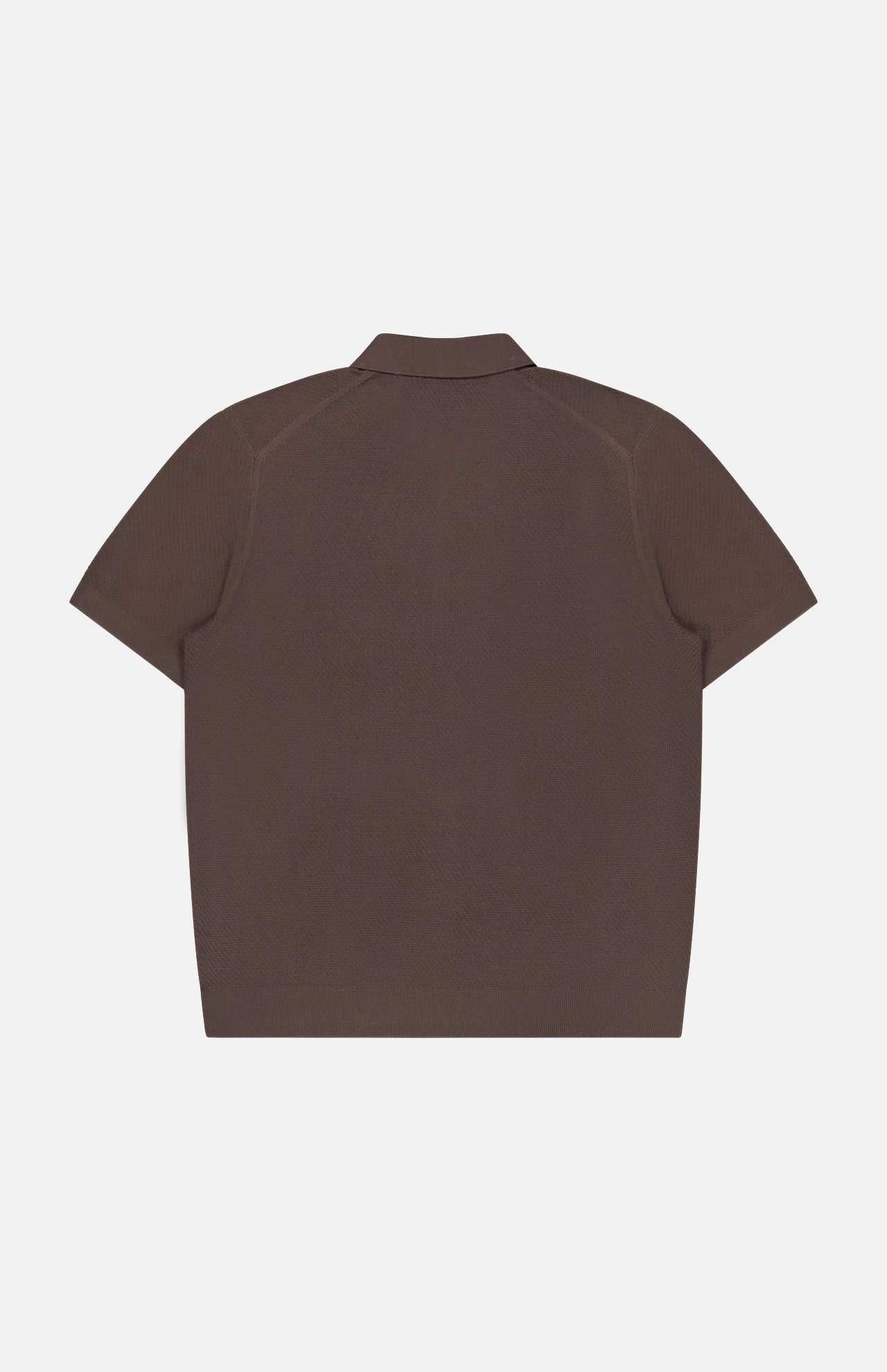 The THEORY Soris Short Sleeve Polo Shirt is displayed from the back, laid flat on a plain white background. This men’s transitional knit polo features a classic collar and a minimalist design with no visible logos, patterns, or extra details.