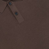 Close-up of the Soris Short Sleeve Polo Shirt in brown, featuring a textured knit fabric, a collar, and two buttons. The THEORY brand label is visible near the neckline, emphasizing this men’s transitional piece that seamlessly combines versatility and style.