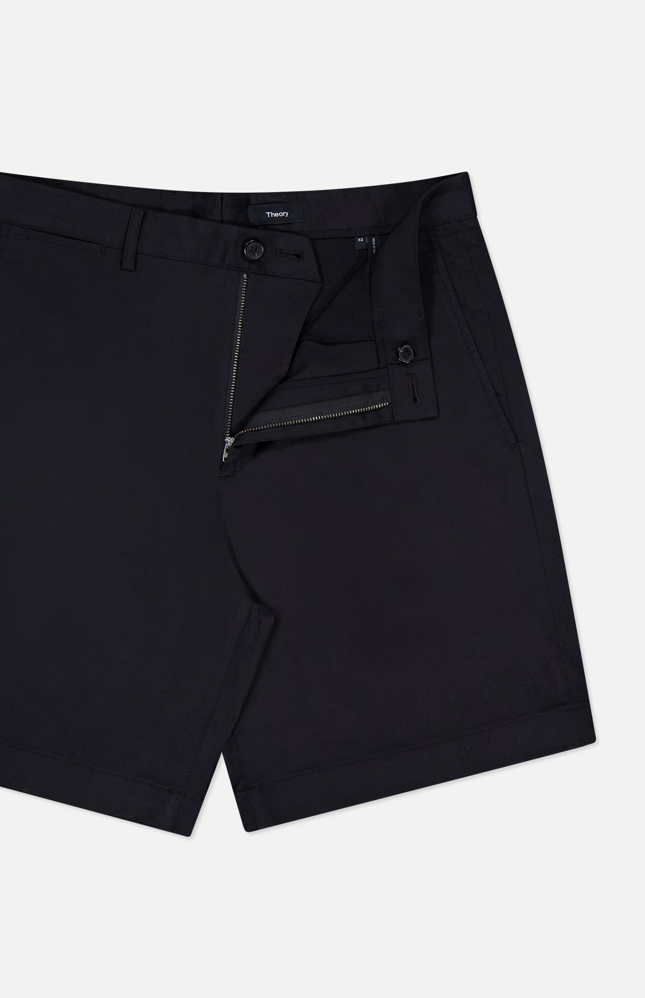 THEORY Standard Chino Moons Shorts: men's black cotton twill shorts with a minimal design, side pockets, and partially open waistband, button, and zip fly. Displayed on a white background.