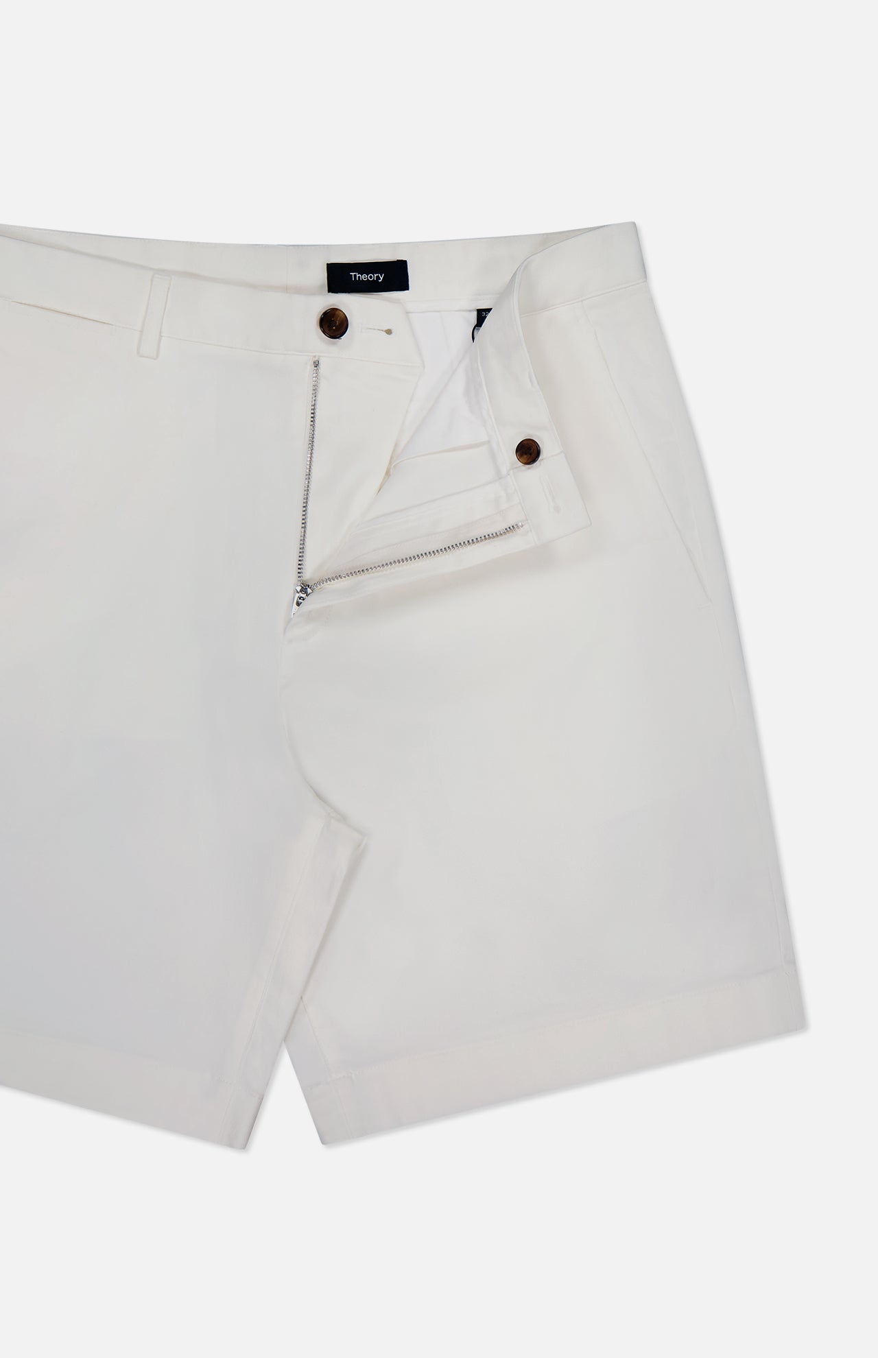 THEORY's Standard Chino Moons Shorts feature white cotton twill, a front zipper and button closure, belt loops, side pockets, and a partially unzipped design showing the interior waistband detail.