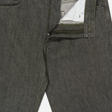 A close-up of THEORY’s Standard 5-Pocket Jeans in olive green, with the zipper and button undone to reveal the inside waistband and pocket lining. Crafted from stretch-cotton denim, these jeans feature a textured fabric with a subtly faded appearance.