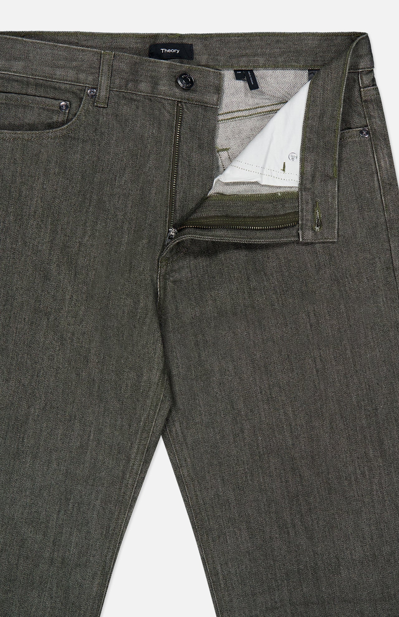 A close-up of THEORY’s Standard 5-Pocket Jeans in olive green, with the zipper and button undone to reveal the inside waistband and pocket lining. Crafted from stretch-cotton denim, these jeans feature a textured fabric with a subtly faded appearance.