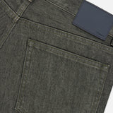 Close-up of the back pocket and waistband of dark gray, stretch-cotton Standard 5-Pocket Jeans by THEORY, featuring a black leather patch with the brand name in small text. The denim has a subtle texture and a classic five-pocket design.