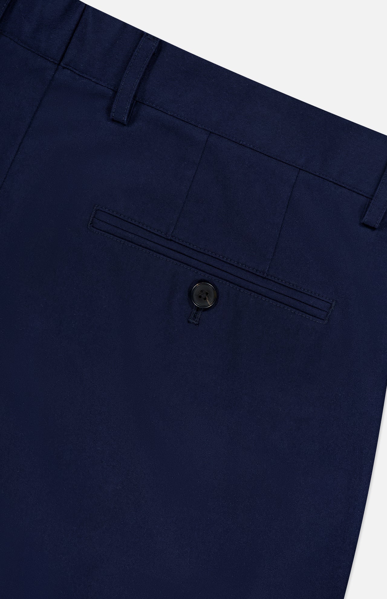 Close-up of the back pocket on RAG & BONE Standard Moons Shorts in navy, showing a single button closure, belt loop, and neatly stitched stretch fabric.