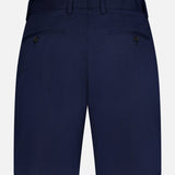 Back view of RAG & BONE Standard Moons Shorts for men in navy cotton, featuring belt loops, two buttoned back pockets, and a tailored design against a white background.