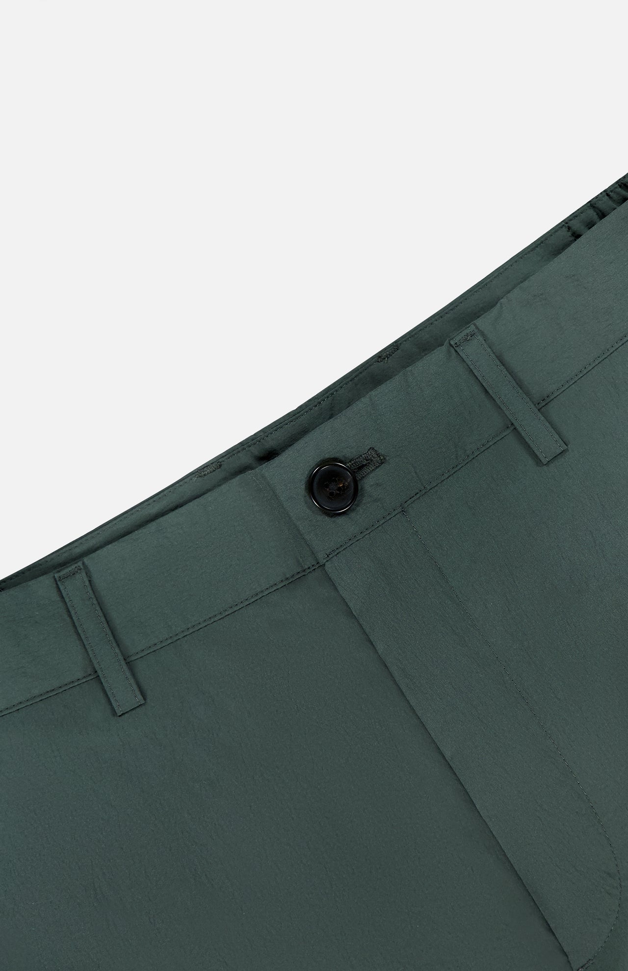 Close-up of the waistband and upper section of THEORY's Standard Nylon Drawstring Trouser Pants in dark green, showing a black button, belt loops, elasticized waist, and front seam against a light gray background.