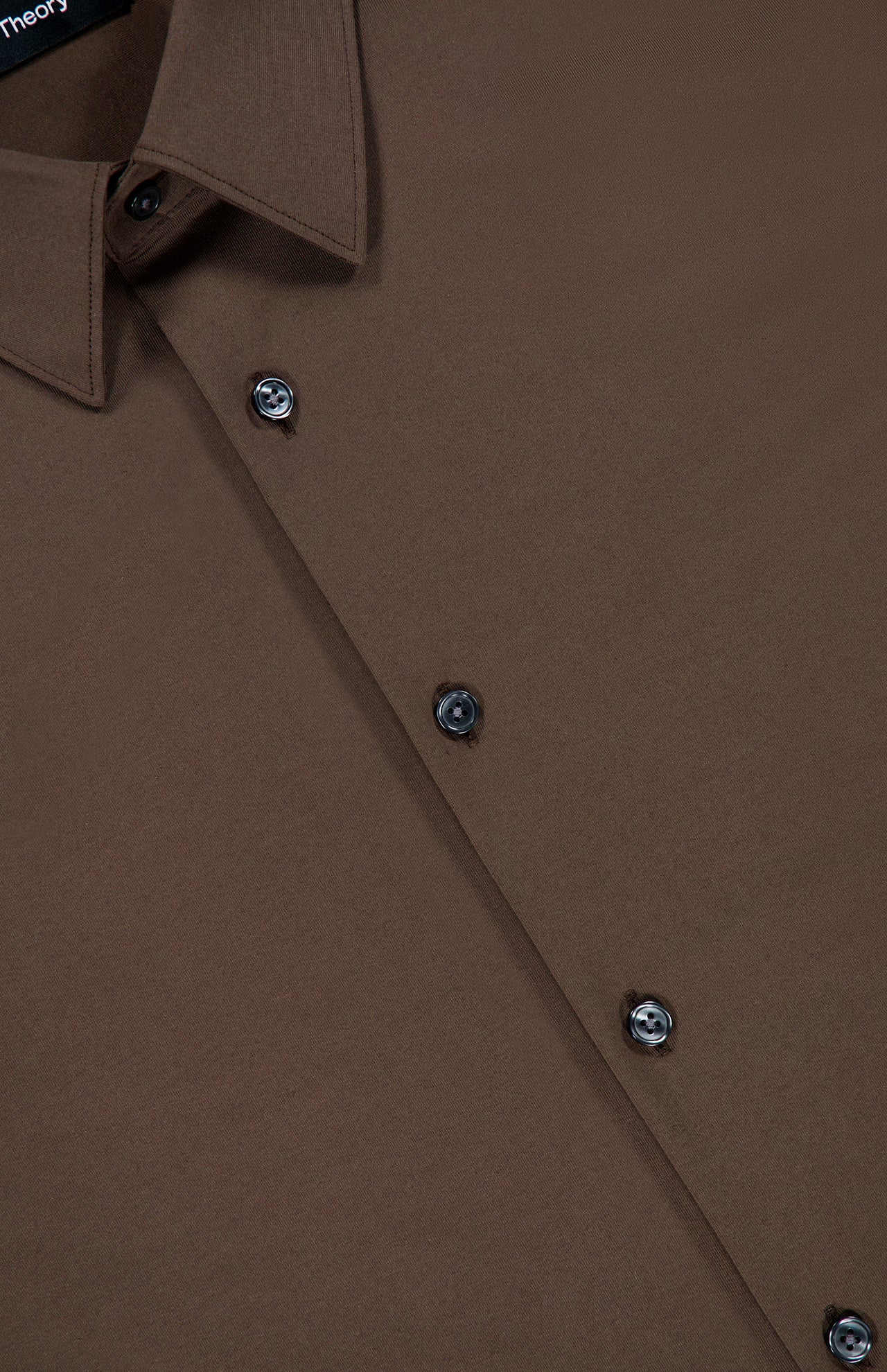A close-up of the Sylvain Structure Dress Shirt by THEORY, a wrinkle-resistant chocolate brown dress shirt featuring a collar and black buttons, displayed on a flat surface.
