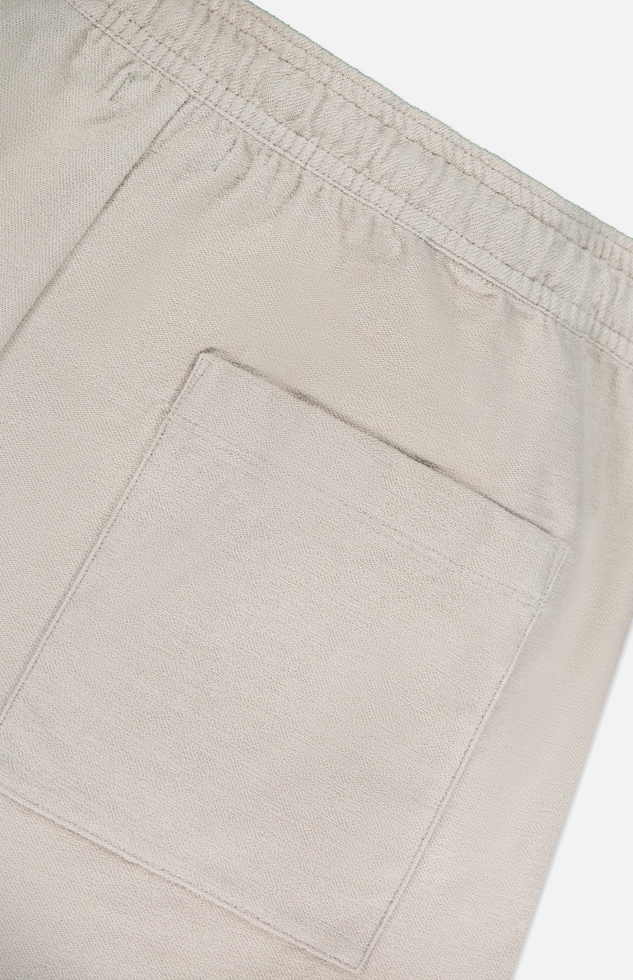 Close-up of the back pocket and elastic waistband on THEORY Terry Drawstring Shorts, featuring soft fabric texture and detailed stitching for a relaxed fit.