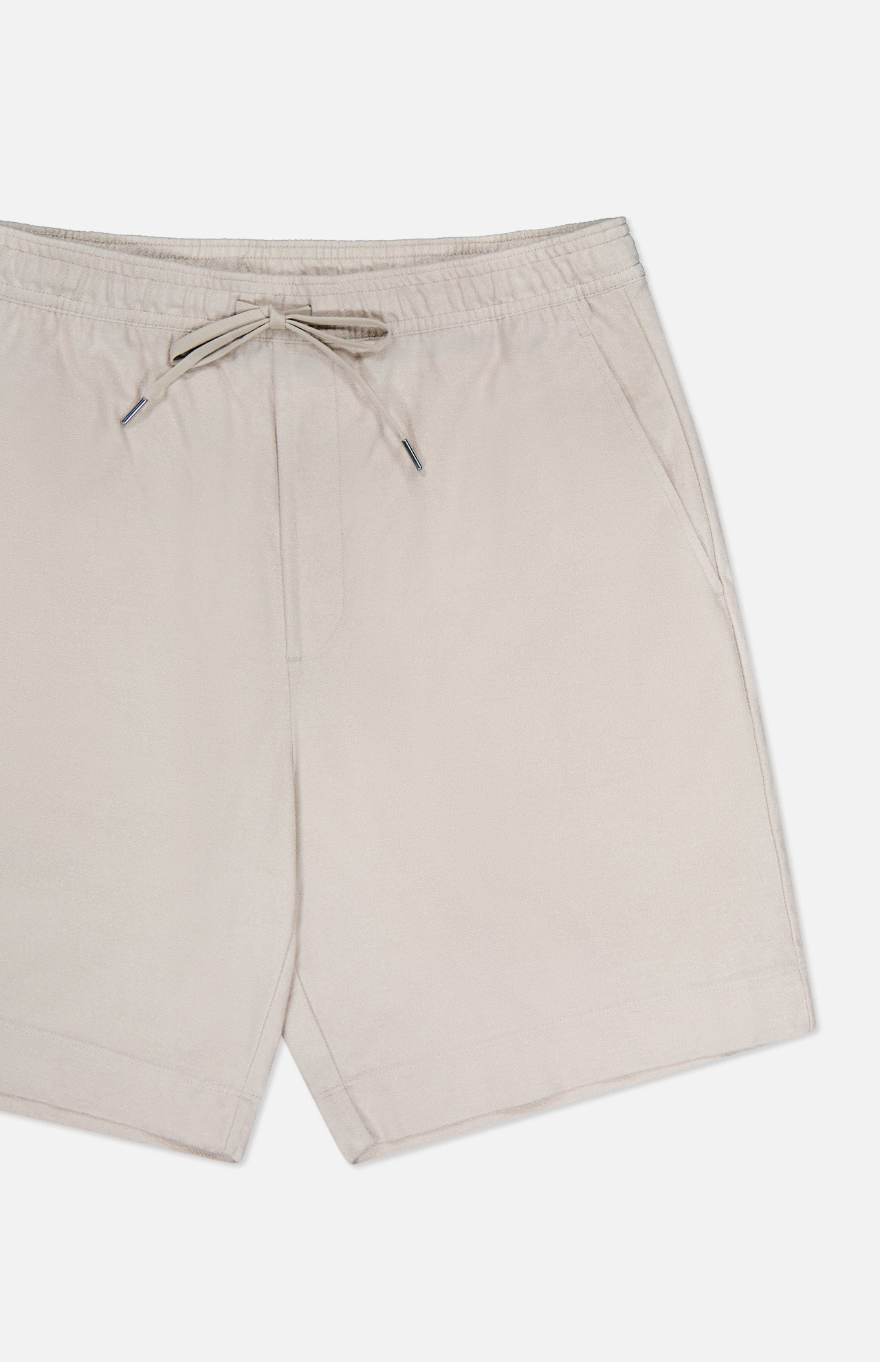 THEORY Terry Drawstring Shorts in beige, featuring an adjustable waist and side pockets, are shown front-facing against a white background. Lightweight fabric offers a casual look ideal for warm weather.