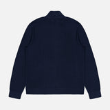 The THEORY Walton Full Zip Sweater in navy blue features long sleeves and a textured knit cotton design, shown laid flat from the back on a white background.
