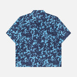 The THEORY Weekend Short Sleeve Shirt features a boxy fit, pointed collar, and blue/navy abstract camo print on a cotton blend. Displayed flat on a white background.