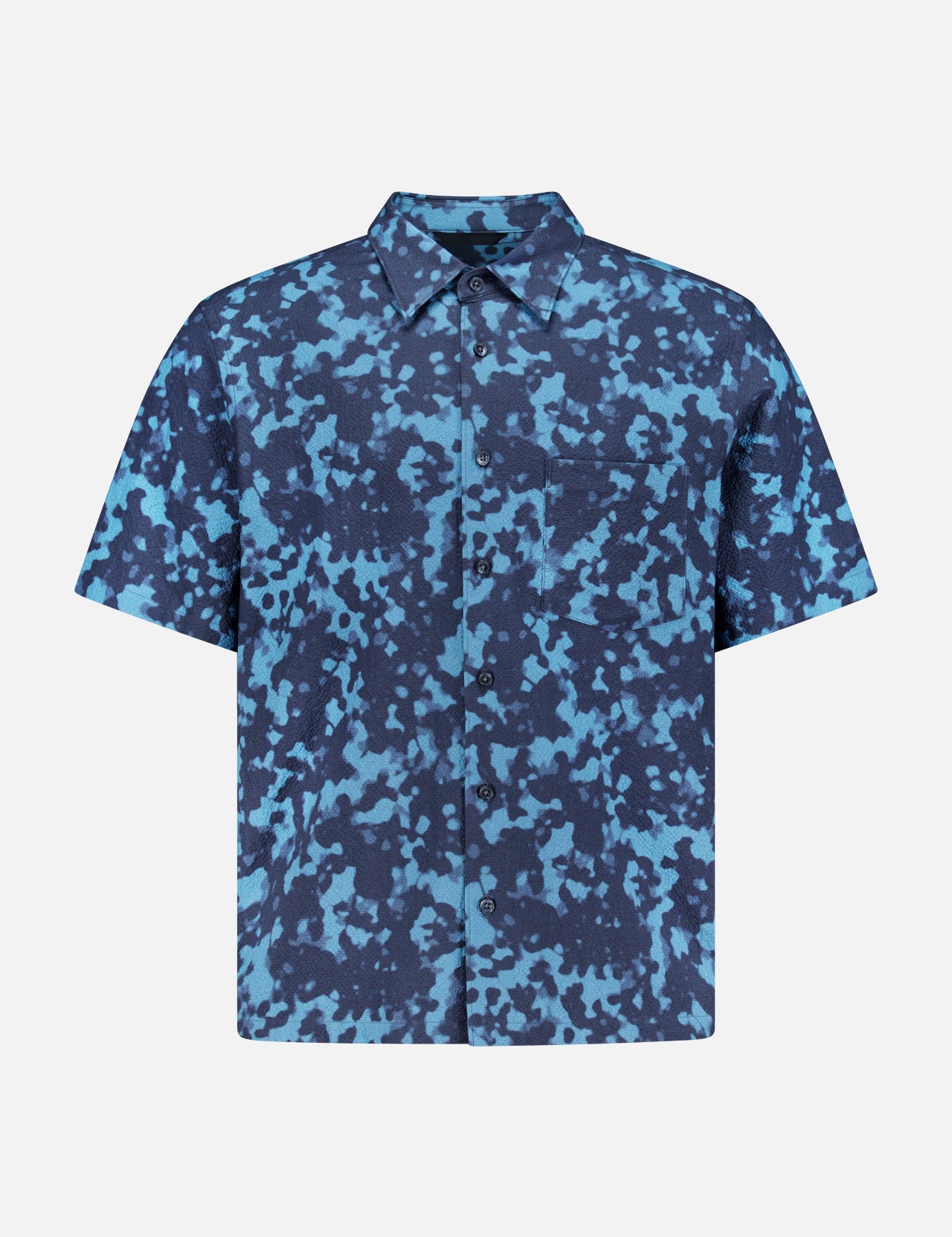 The THEORY Weekend Short Sleeve Shirt features a cotton blend, button-up design with blue and navy abstract camouflage pattern and a left chest pocket, shown on a plain white background.