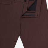 Close-up of THEORY's Raffi Stretch Twill Pants in dark brown, featuring a slim fit, partially open front zipper and button, visible waistband and interior details, a small front pocket, belt loops, and comfortable 4-way stretch fabric.