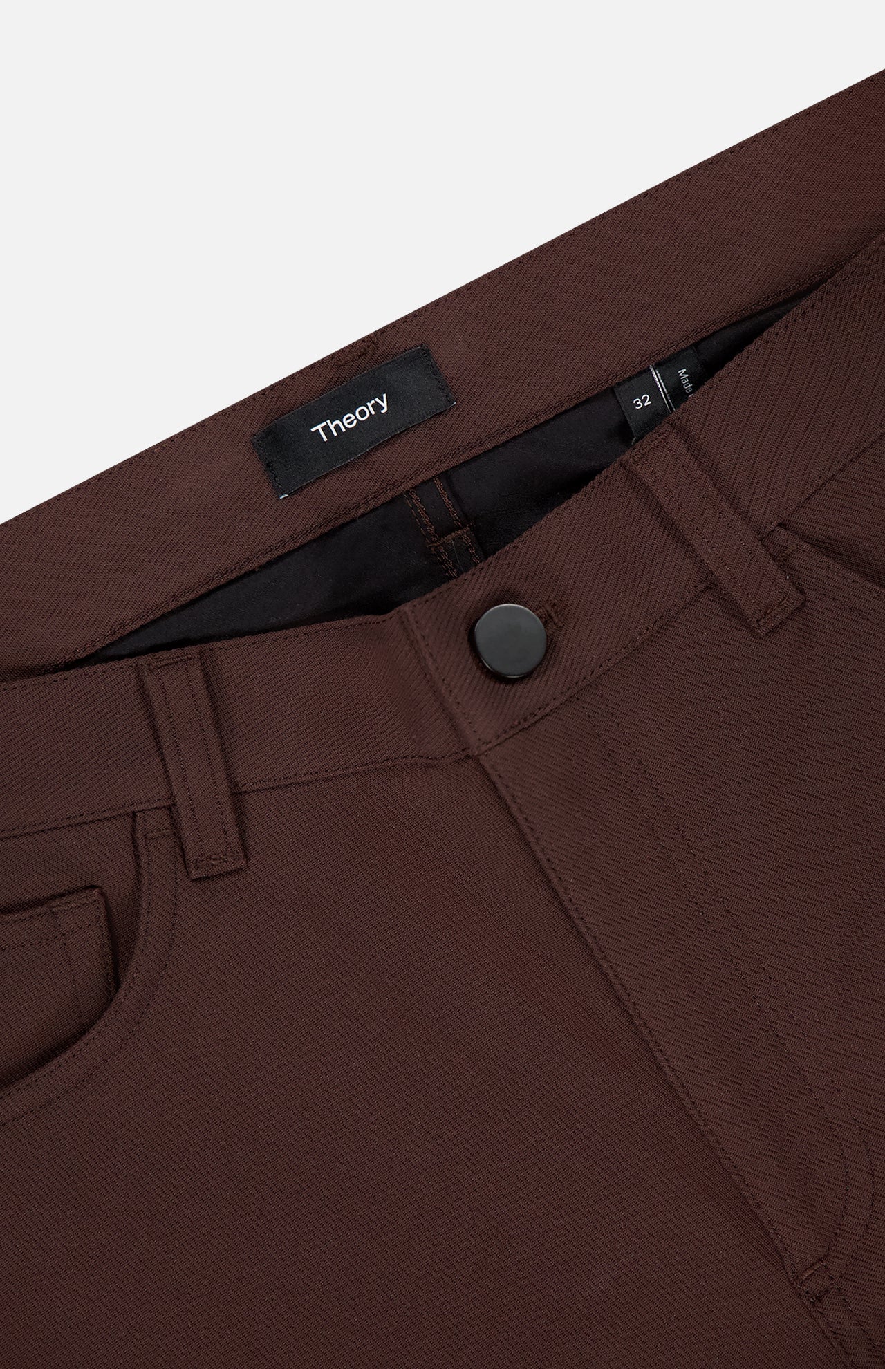 Close-up of the waistband and front pocket of Raffi Stretch Twill Pants by THEORY in slim fit dark brown, featuring a black button, belt loops, and an inner waistband label with the brand name.