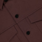 Close-up of the River Twill Trucker Jacket by THEORY, featuring black buttons, two flap chest pockets, and a visible collar. Made from textured twill performance fabric for breathability and comfort.