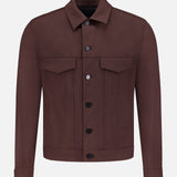 The THEORY River Twill Trucker Jacket in brown features a collar, two flap chest pockets, long sleeves, and is crafted from breathable performance fabric, shown against a white background.